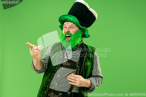 Image of A man in a leprechaun hat at studio. He celebrates St. Patrick\'s Day.