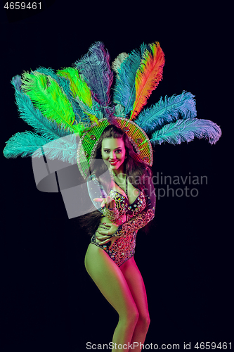 Image of Beautiful young woman in carnival peacock costume