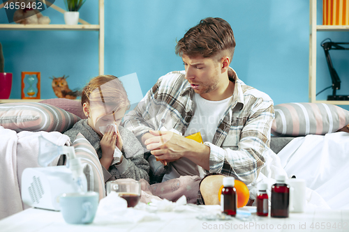 Image of Sick man with daughter at home. The ill family.