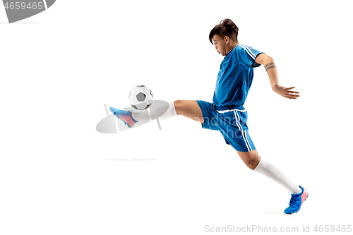 Image of Young boy with soccer ball doing flying kick