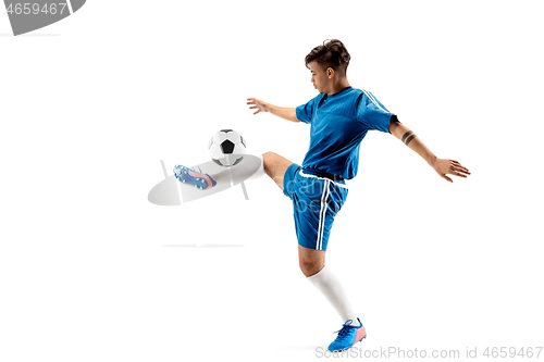 Image of Young boy with soccer ball doing flying kick