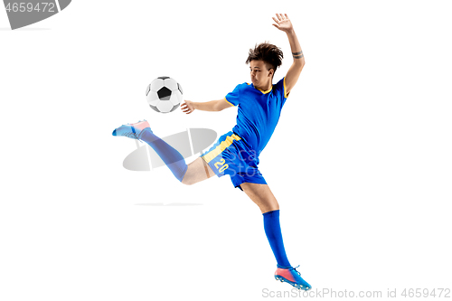 Image of Young boy with soccer ball doing flying kick