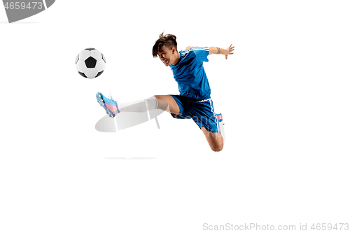 Image of Young boy with soccer ball doing flying kick