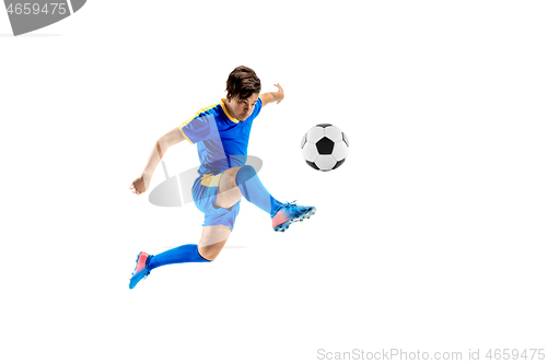 Image of Young boy with soccer ball doing flying kick