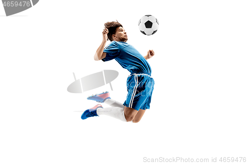 Image of Young boy with soccer ball doing flying kick