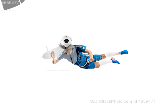 Image of Young boy with soccer ball doing flying kick