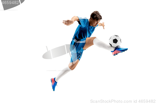 Image of Young boy with soccer ball doing flying kick