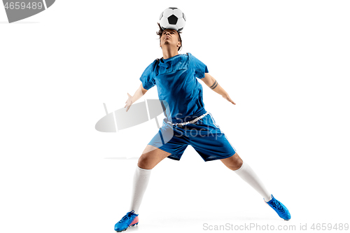 Image of Young boy with soccer ball doing flying kick