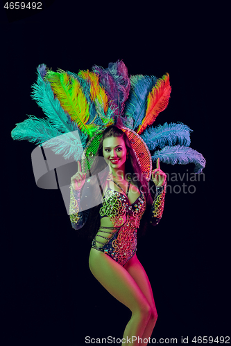 Image of Beautiful young woman in carnival peacock costume