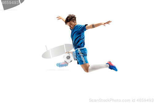 Image of Young boy with soccer ball doing flying kick