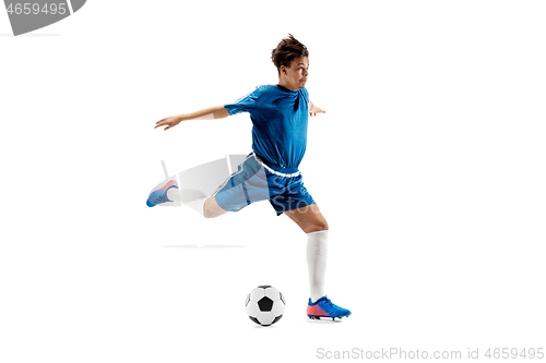 Image of Young boy with soccer ball doing flying kick