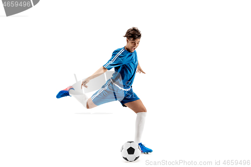 Image of Young boy with soccer ball doing flying kick