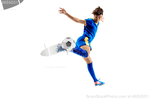 Image of Young boy with soccer ball doing flying kick