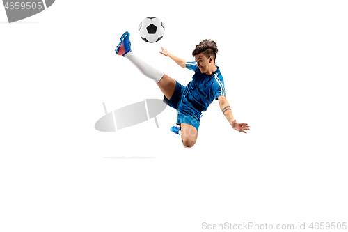 Image of Young boy with soccer ball doing flying kick