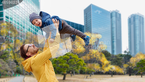 Image of father with son having fun in autumn tokyo city