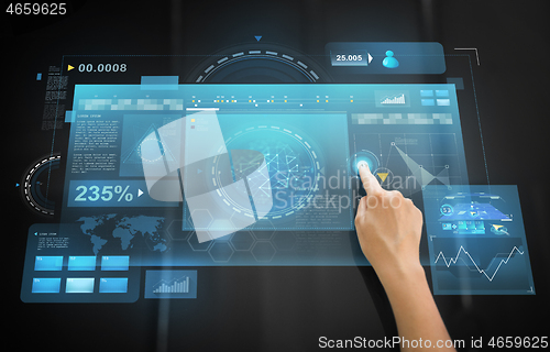 Image of hand using black interactive panel with charts