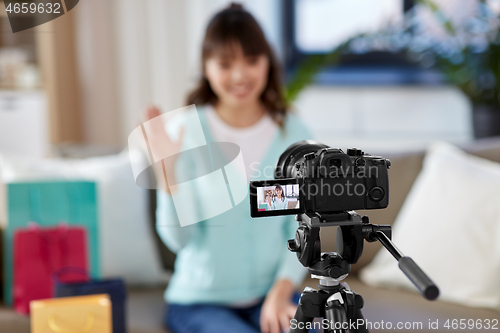 Image of female blogger making video blog about shopping