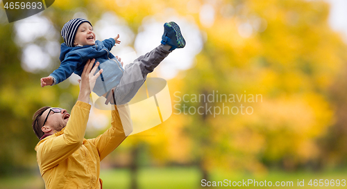 Image of father with son playing and having fun in autumn