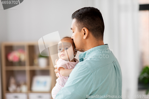 Image of middle aged father with baby daughter at home