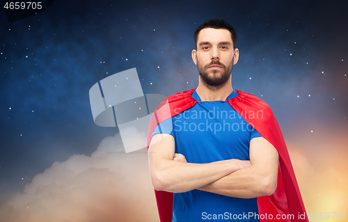 Image of man in red superhero cape over night sky