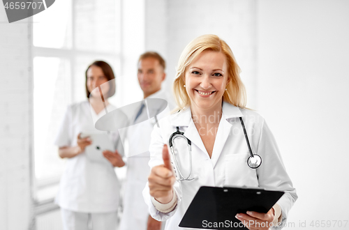 Image of smiling doctor showing thumbs up at hospital