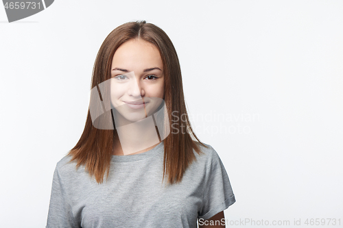 Image of Smiling relaxed teen girl looking at camera