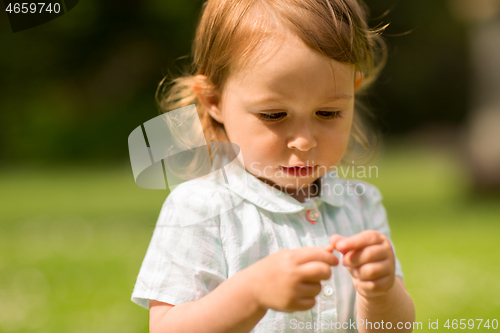 Image of happy little girl at park in summer