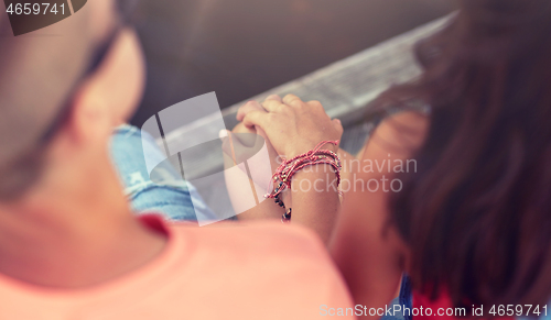 Image of close up of happy teenage couple hands