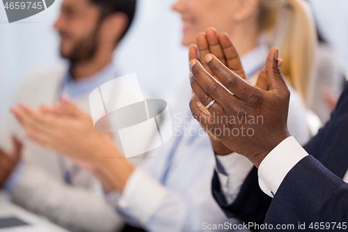 Image of happy people applauding at business conference