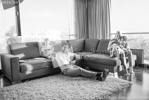 Image of Happy Young Family Playing Together on sofa