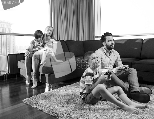 Image of Happy family playing a video game