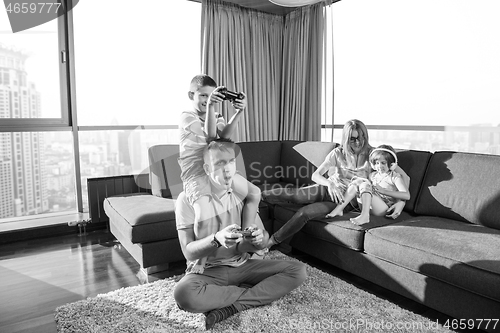 Image of Happy family playing a video game