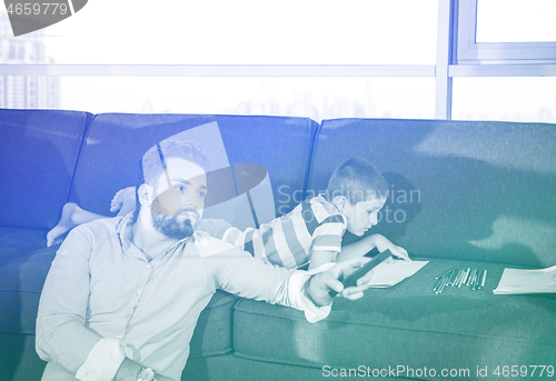 Image of Happy Young Family Playing Together on sofa