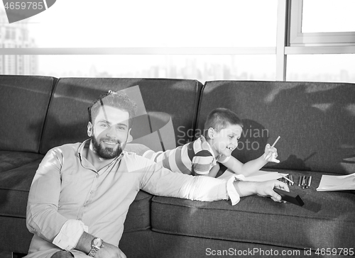 Image of Happy Young Family Playing Together on sofa