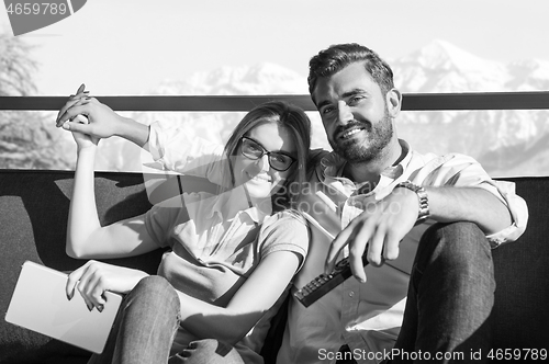 Image of Young couple watching television