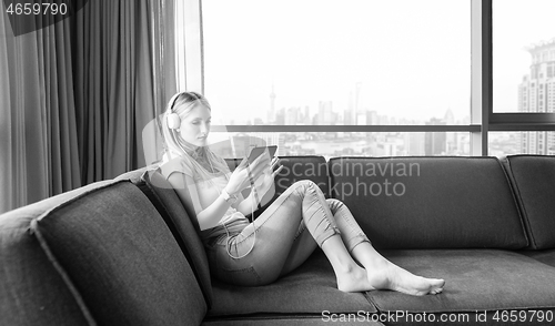 Image of young girl enjoying music through headphones