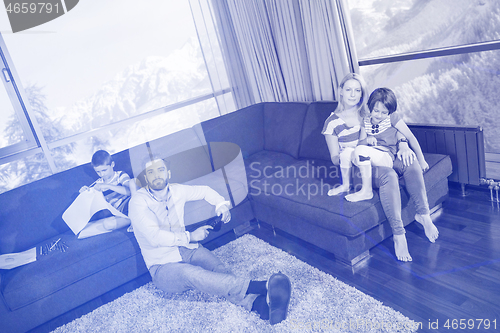 Image of Happy Young Family Playing Together on sofa