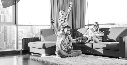 Image of Happy family playing a video game