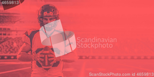 Image of American Football Player isolated on big modern stadium field