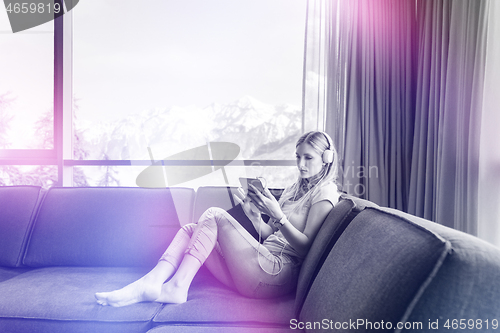 Image of young girl enjoying music through headphones
