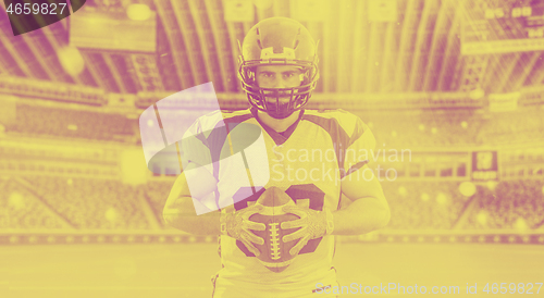 Image of American Football Player isolated on big modern stadium field