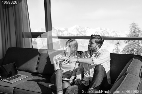 Image of Young couple watching television