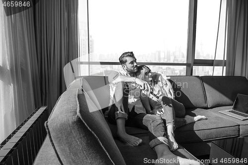 Image of Young couple watching television