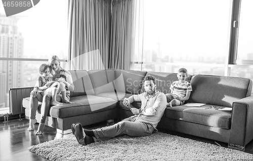 Image of Happy Young Family Playing Together on sofa