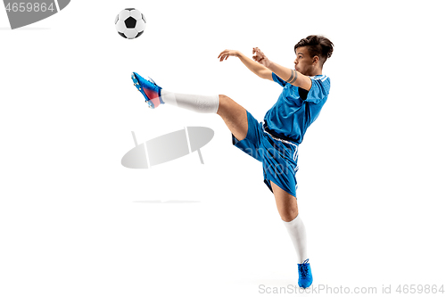 Image of Young boy with soccer ball doing flying kick