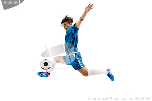 Image of Young boy with soccer ball doing flying kick