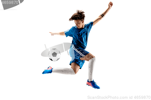 Image of Young boy with soccer ball doing flying kick