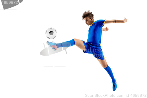 Image of Young boy with soccer ball doing flying kick