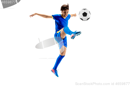 Image of Young boy with soccer ball doing flying kick