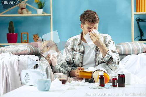 Image of Sick man with daughter at home. The ill family.